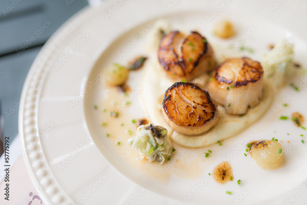 Grilled scallops on white plate