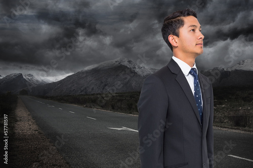 Composite image of landscape with stormy sky