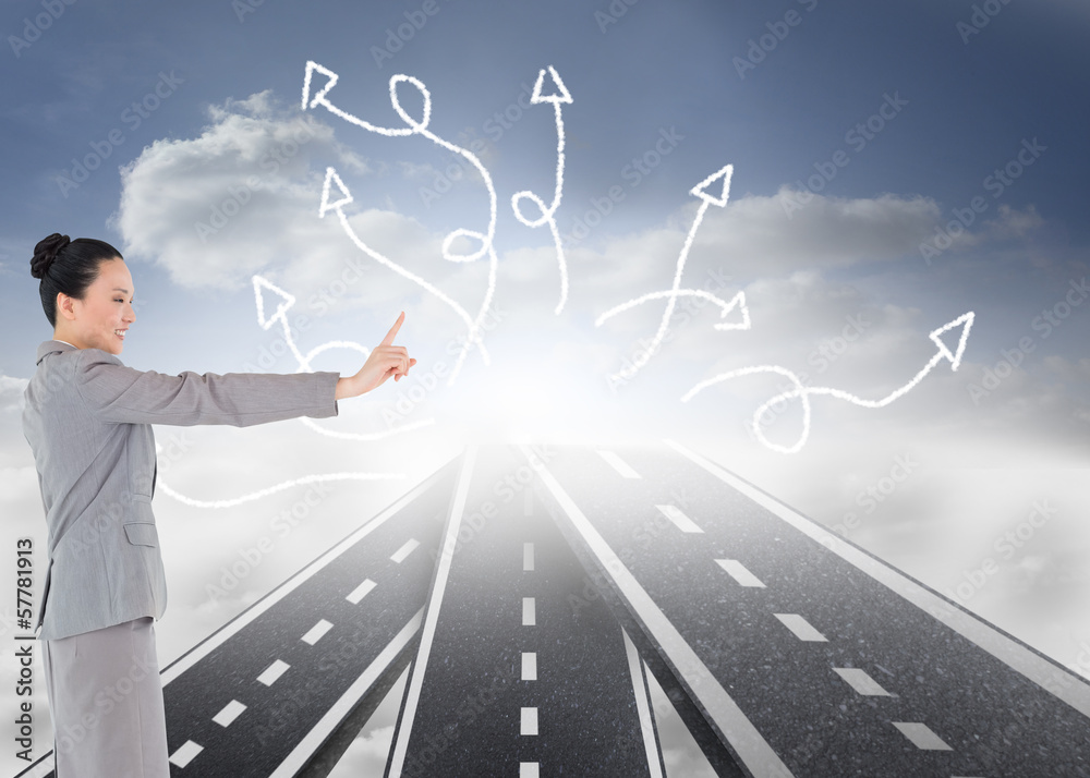 Composite image of smiling asian businesswoman pointing Composite image of smiling asian businesswoman pointing