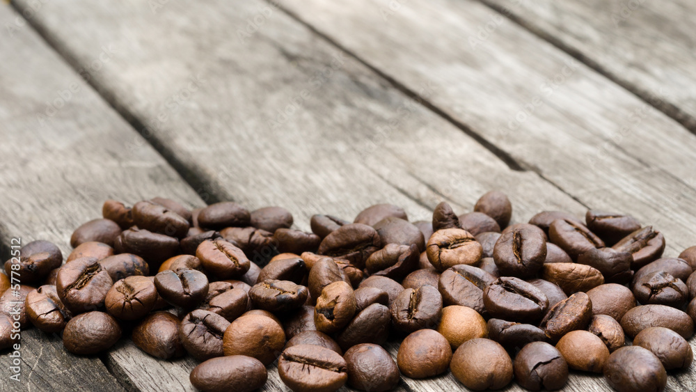 coffee beans close up on old wooden table coffee beans close up on old wooden table