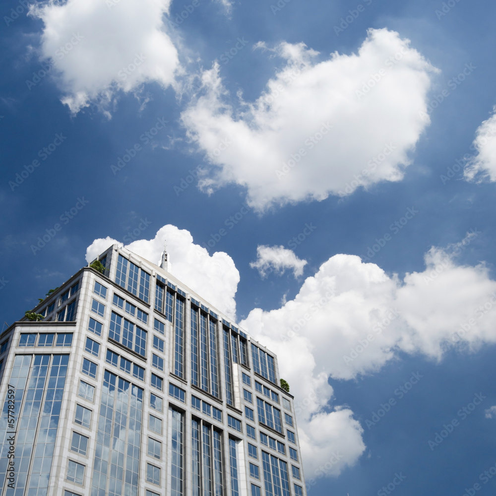 clouds over modern building with blue sky background