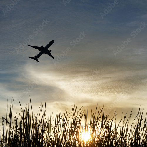 Silhouette of an airplane with sunset sky