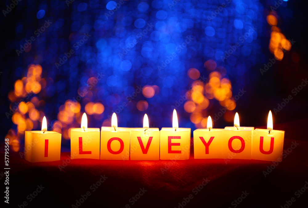 Candles with printed sign I LOVE YOU,on  blur lights background