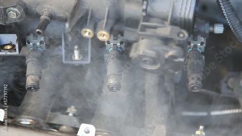 Automotive, car engine injectors splashing gasoline