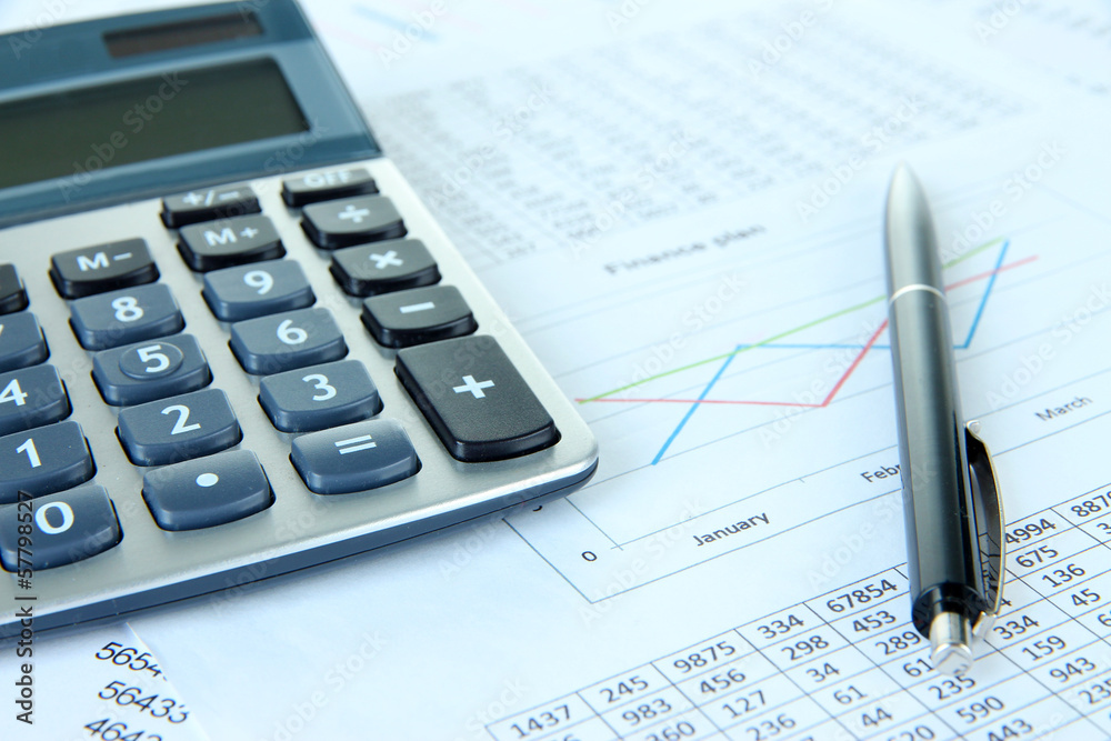 Calculator and pen with documents close up Calculator and pen with documents close up