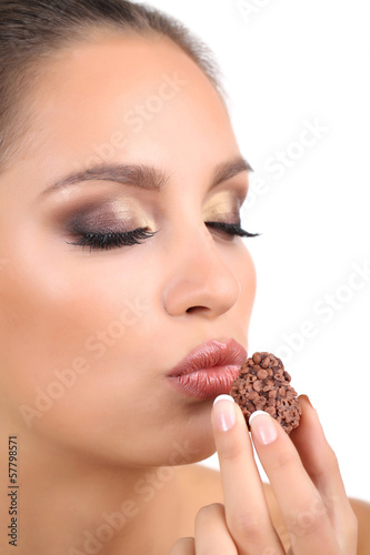 Portrait of beautiful young girl with chocolate candy isolated