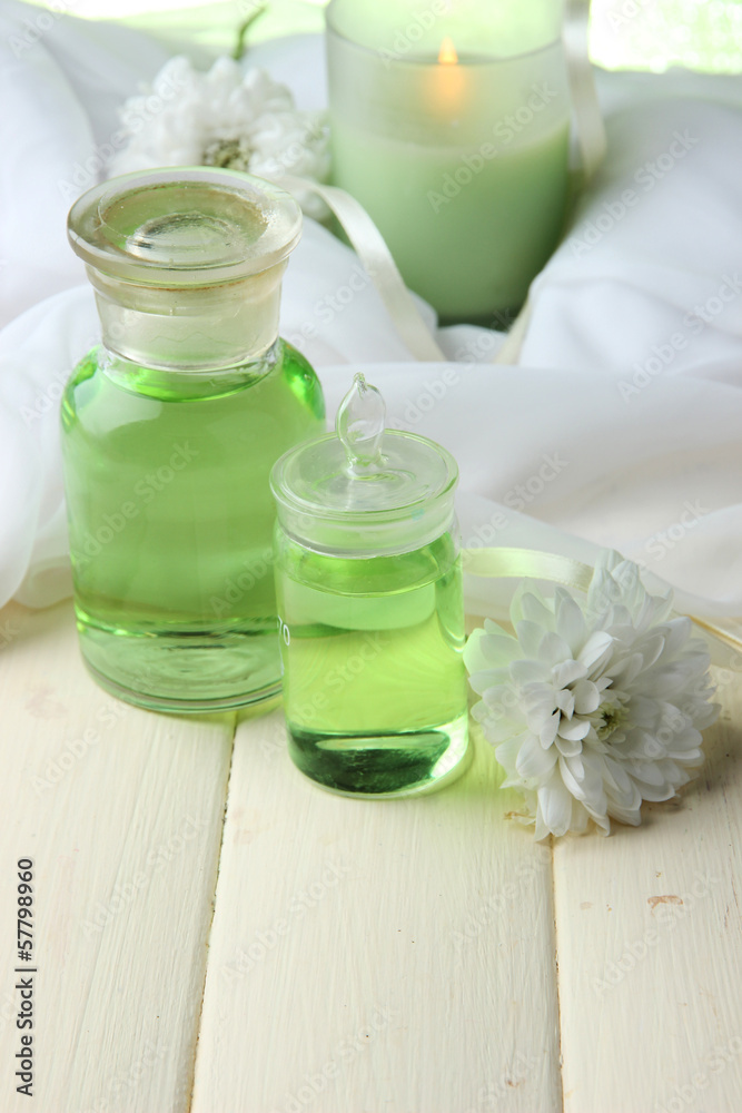 Glass bottles with color essence, on wooden background Glass bottles with color essence, on wooden background