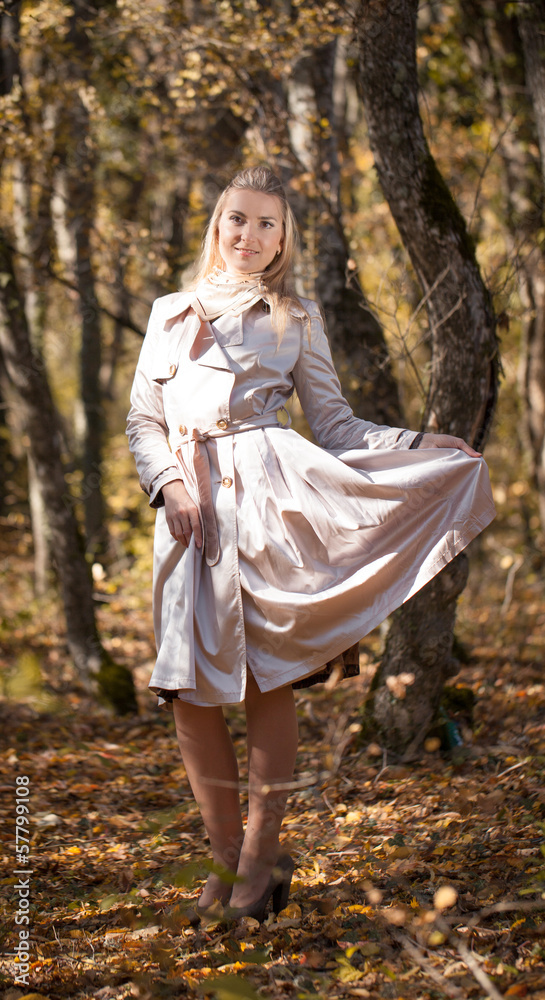 Beautiful blond young woman wearing cloak outdoors Beautiful blond young woman wearing cloak outdoors