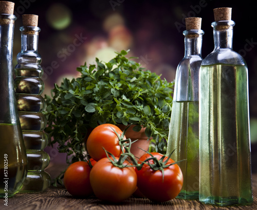 Collection of bottles with olive oil,tomateos, fresh basil photo