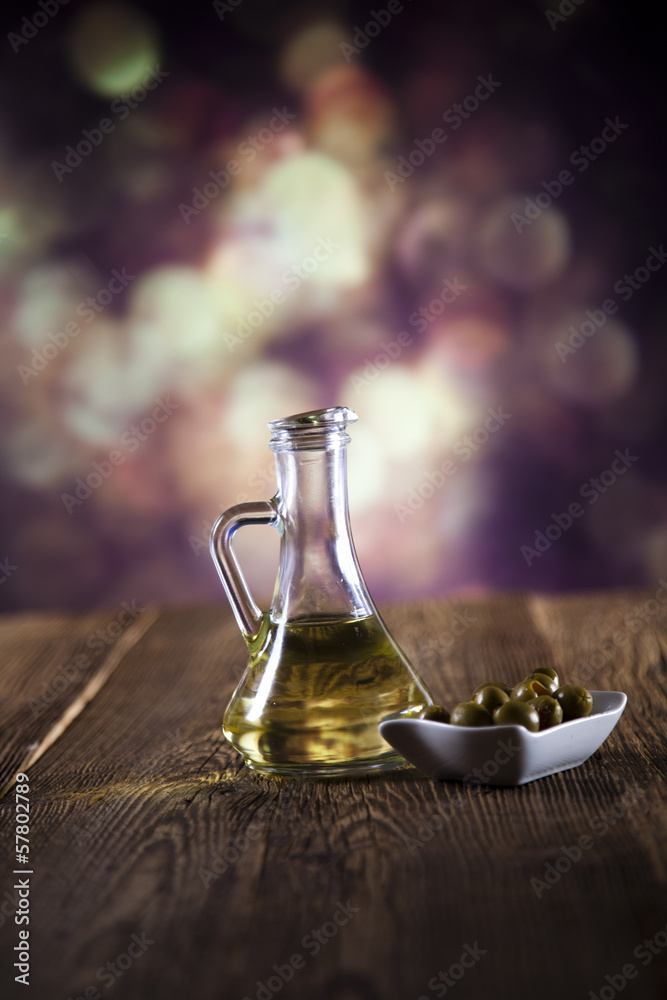 Flagon with olive oil, fresh olives on a plate Flagon with olive oil, fresh olives on a plate