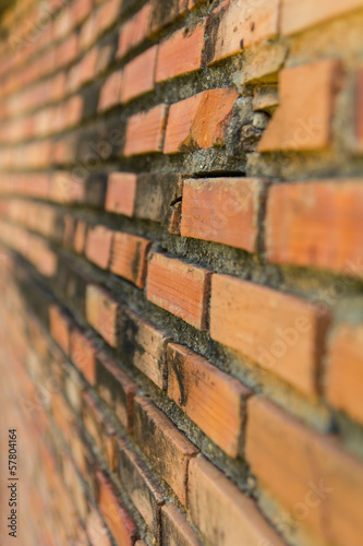 Close-cracks and chipping of old brick wall with weathered