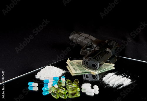 Life is at the edge. Gun, pills, drugs, money on black backgroun