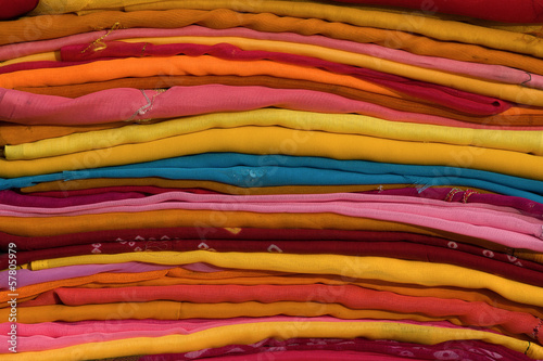 Heap of cloth fabrics at a local market in India. Close up .