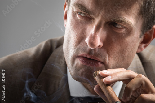 Obraz na plátně Severe gaze of elegant smoker