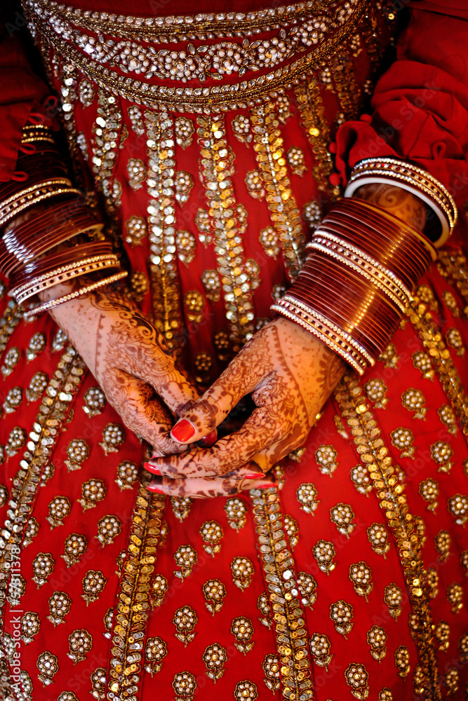 Indian Bride's hands wearing bangles decorated with beautiful he