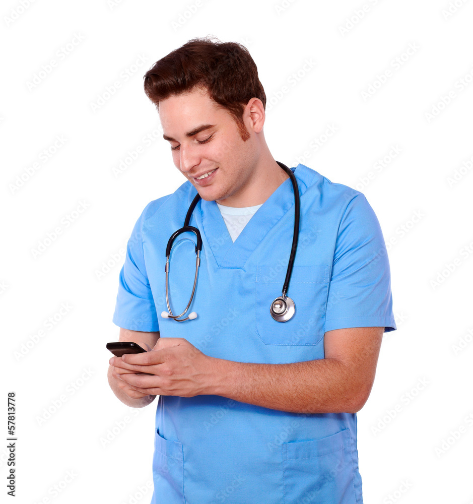 Attractive nurse man texting on cellphone Attractive nurse man texting on cellphone