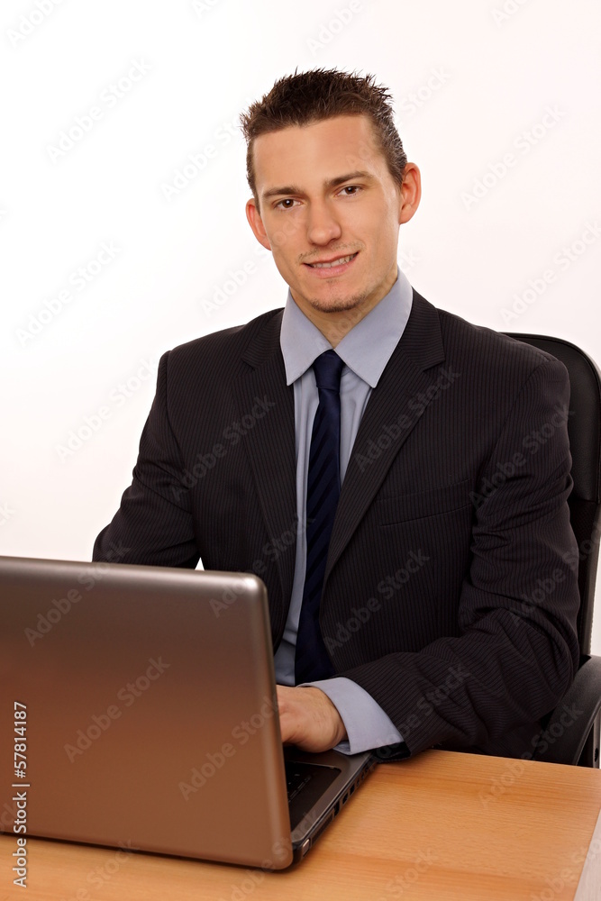 Young businessman at suit works on the notebook Young businessman at suit works on the notebook