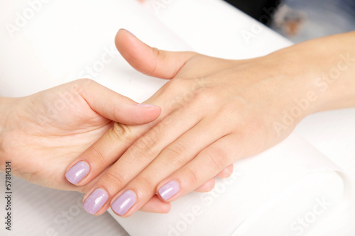 Manicure - Beautiful manicured woman s nails with violet nail po