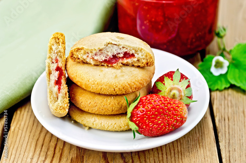Biscuits with strawberries and jam on the board