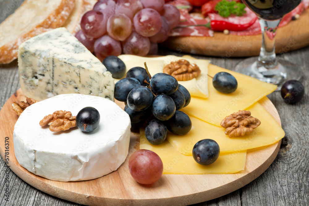 Assorted cheese, grapes, wine and sausages
