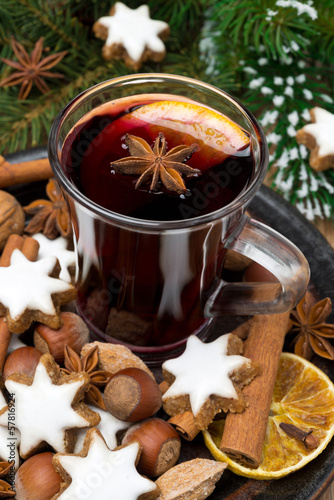 cookies in the shape of stars, spices and a cup of mulled wine