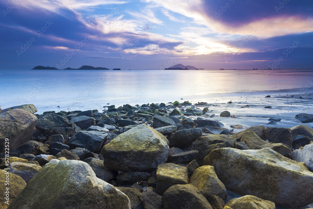 Sea stones along coast at sunset