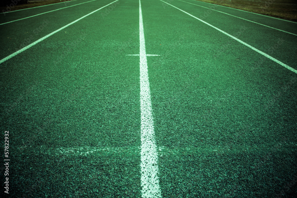 Green athletic field running track with lines