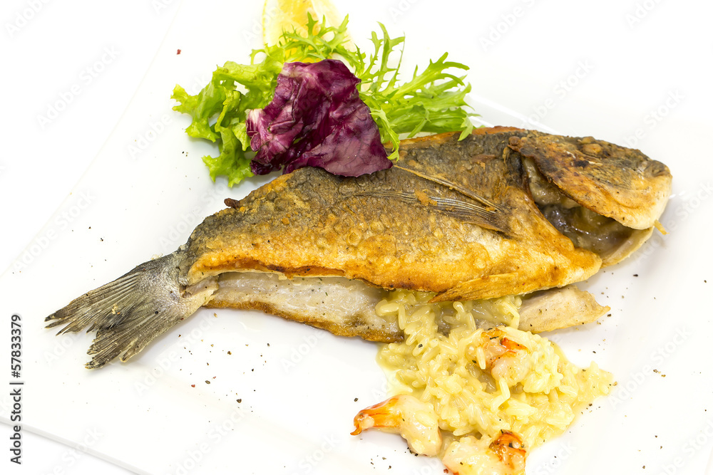 Fried fish dorado with vegetables and lemon Fried fish dorado with vegetables and lemon