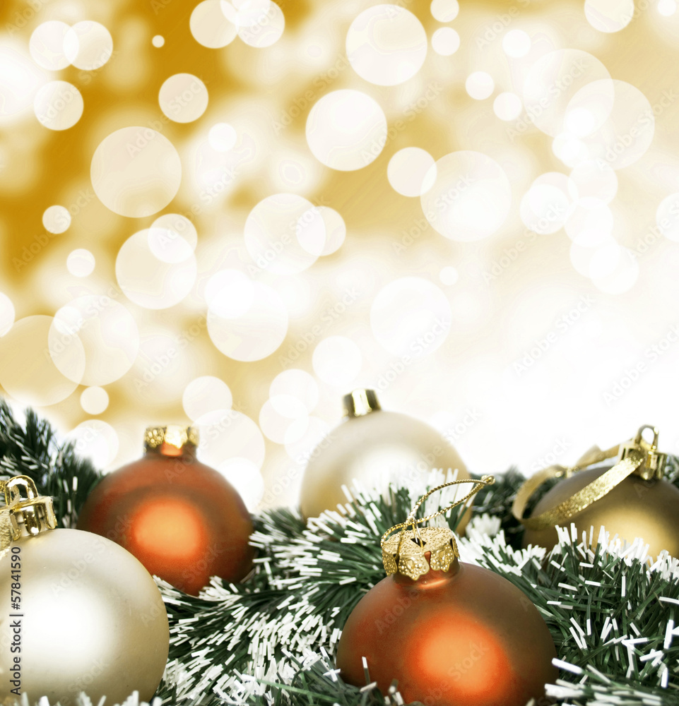 An arrangement of golden Christmas baubles against a festive bok