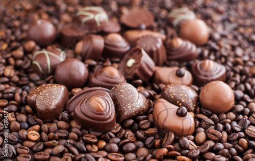 Assorted chocolate pralines on coffee beans background