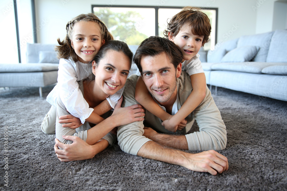 Family at home relaxing on carpet Family at home relaxing on carpet