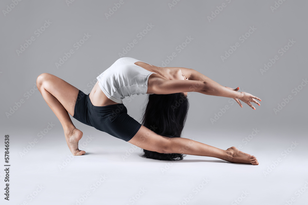 girl doing gymnastic poses in studio girl doing gymnastic poses in studio