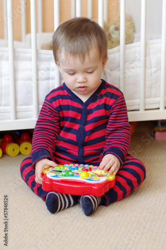 baby plays musical toy