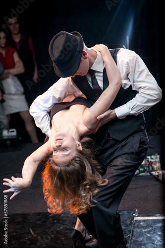 Sexy young couple dancing argentinian tango on stage photo