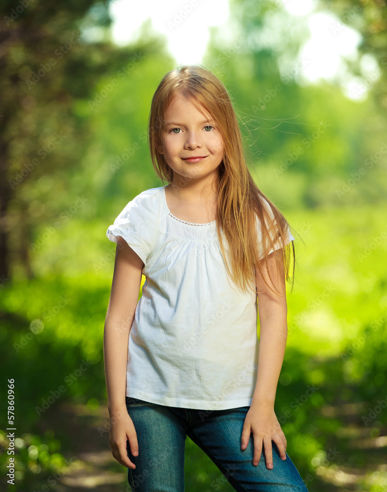Cute young girl staying in the forest