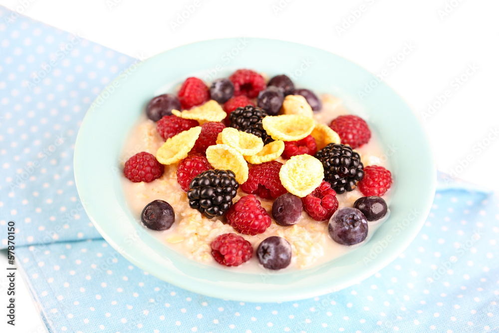 Oatmeal in bowl with berries isolated on white Oatmeal in bowl with berries isolated on white