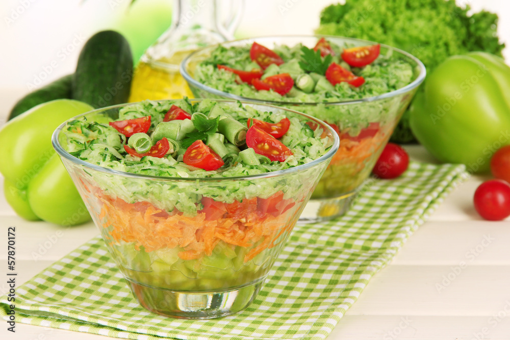 Tasty salad with fresh vegetables on wooden table Tasty salad with fresh vegetables on wooden table