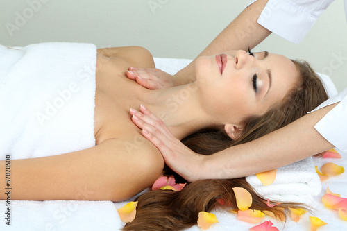 Beautiful young woman during massage in cosmetic salon close up