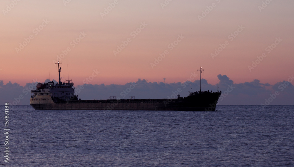 view on cargo ship at sunrise