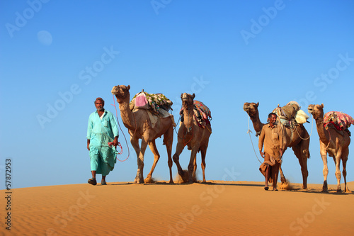 cameleers in desert