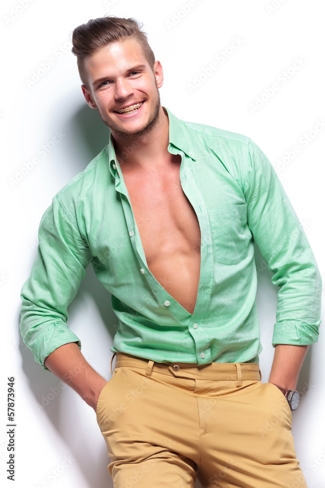 casual man laughing with both hands in pockets casual man laughing with both hands in pockets