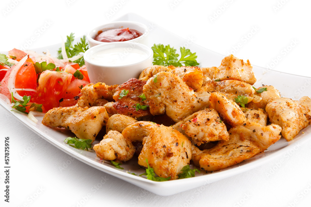 Grilled meat and vegetables on white background