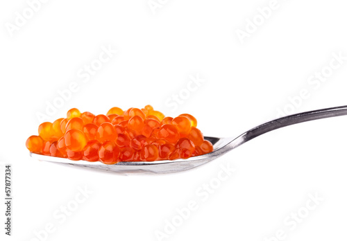 Red caviar in metal spoon isolated on white background