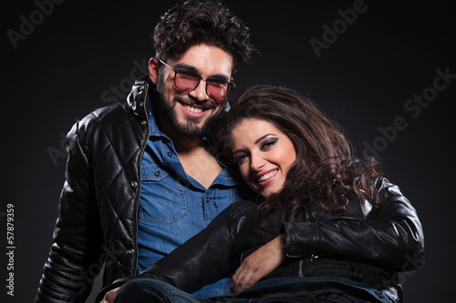 young laughing couple on a dark background