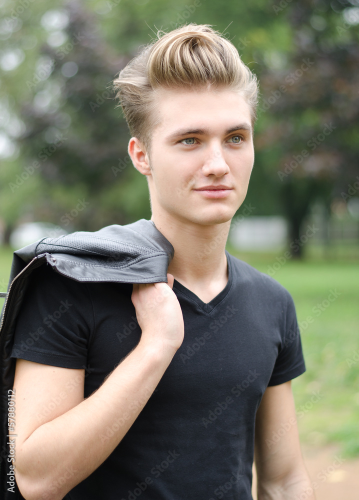 Attractive blond young man outdoors in a park Attractive blond young man outdoors in a park