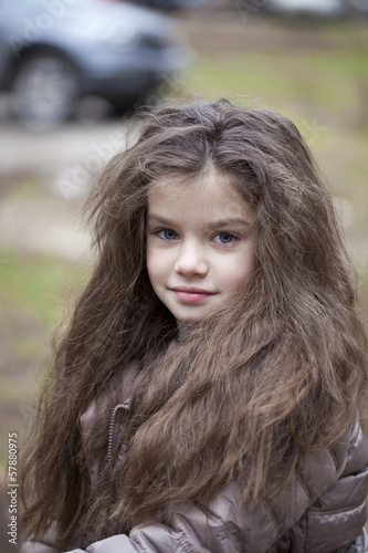Autumn portrait of a beautiful little girl