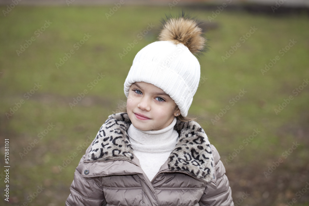 Little girl in a white knitted hat autumn Little girl in a white knitted hat autumn