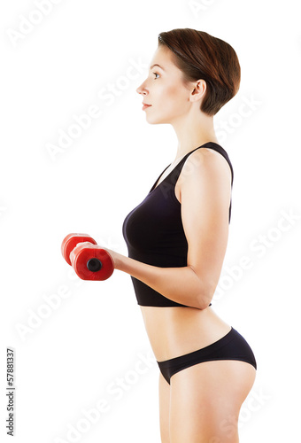 pretty woman is exercising with red dumbbell