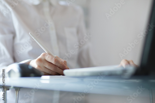 Woman designer using a graphics pad with notebook © rasstock