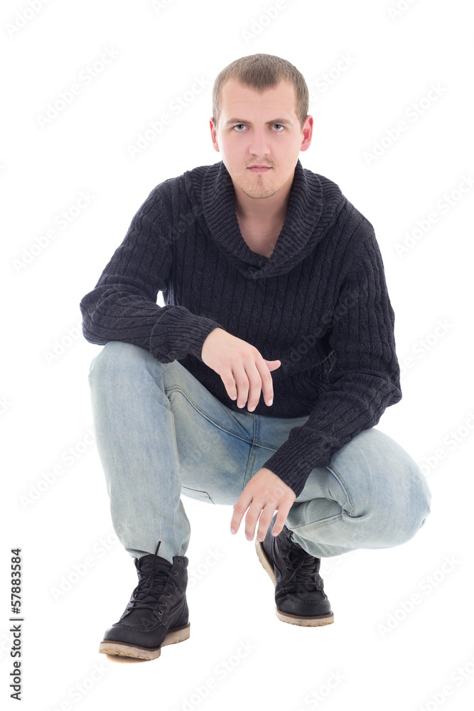 young attractive man in winter clothes sitting isolated on white young attractive man in winter clothes sitting isolated on white